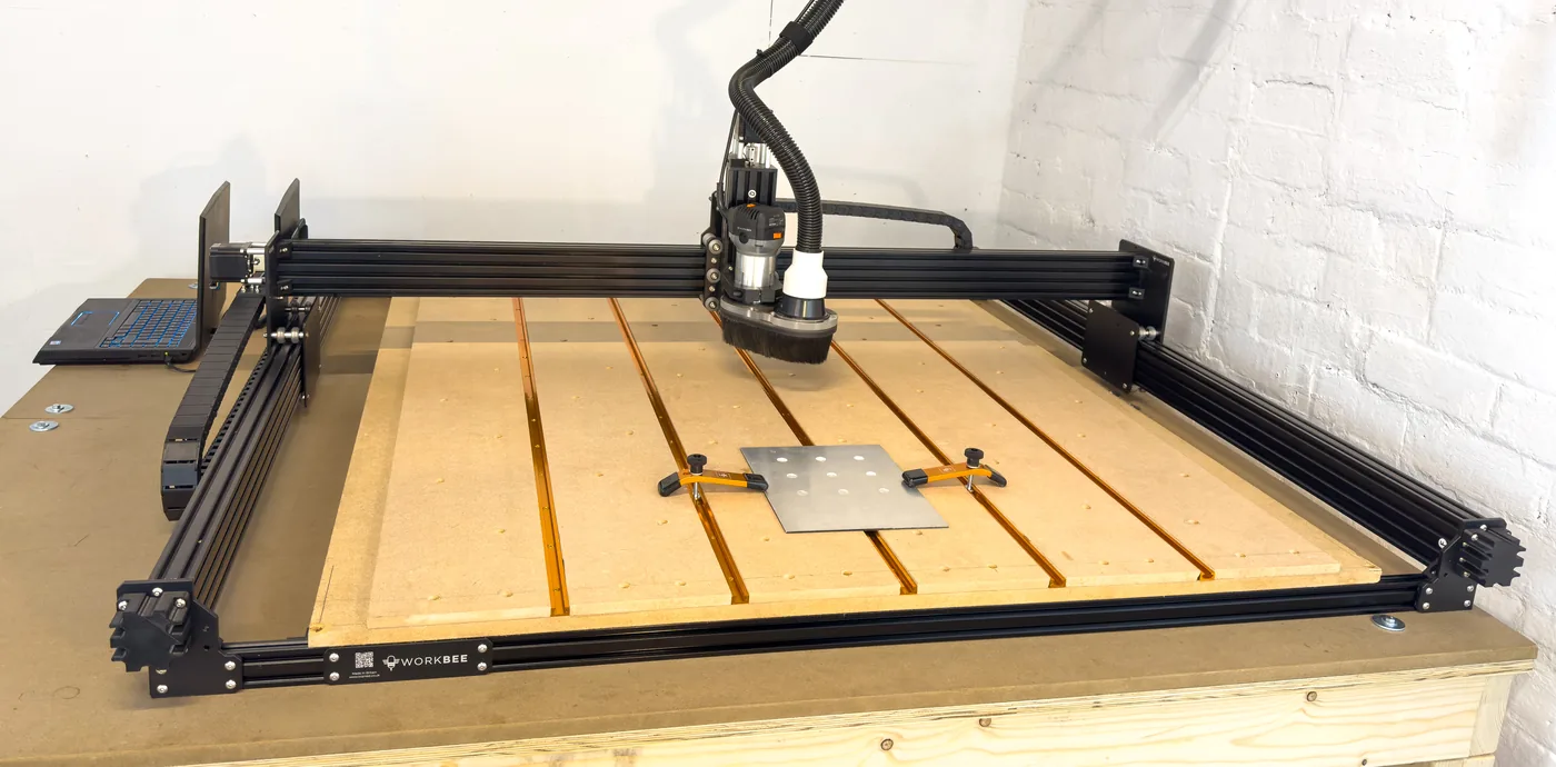 Large-format CNC router with aluminium plate clamped on the work bed at Seked Labs